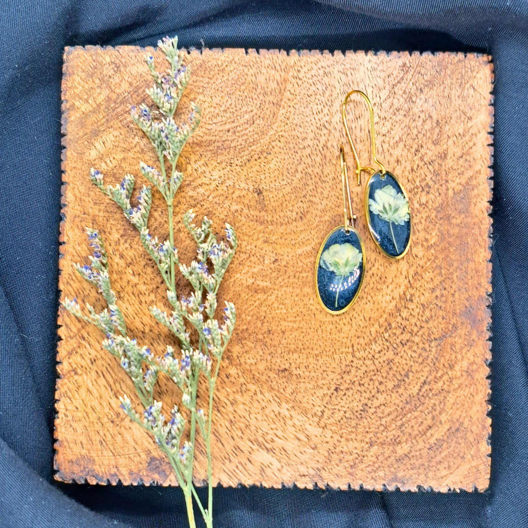 Small Oval Dangle Earring - Real White Pressed Flowers in Black Resin Set in Gold-Plated Stainless Steel